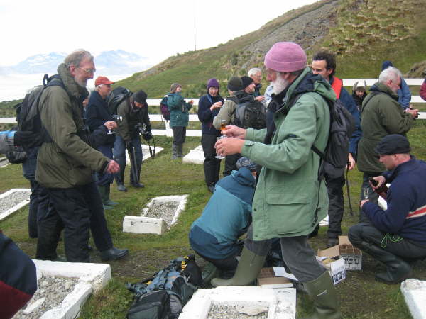 Toasting Sir Ernest Shackleton by his graveside, Grytviken, South Georgia