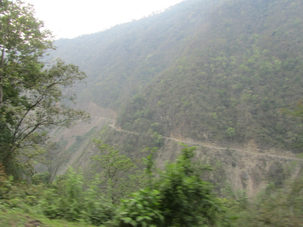 Showing the road is merely a shelf on a mountainside