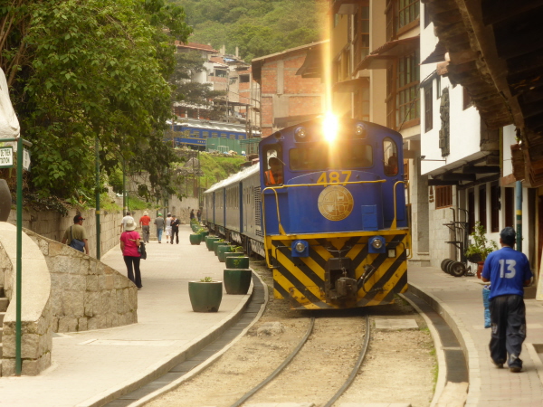 Train running through the centre of Aguas Calientes